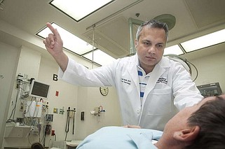 FILE - Dr. Khalid Malik, MD explains the process of testing patients for stroke symptoms at Wadley Regional Medical Center. (Texarkana Gazette file photo/Christena Dowsett)